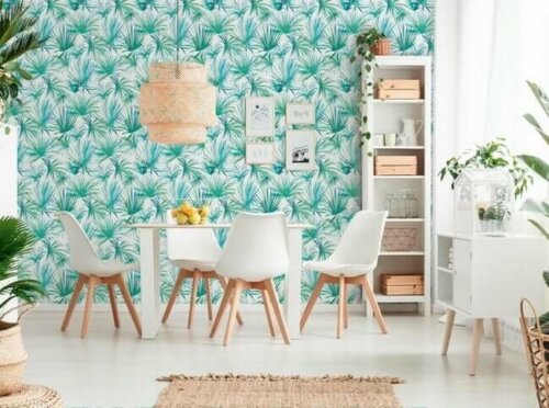 A dining room with painted wallpaper.