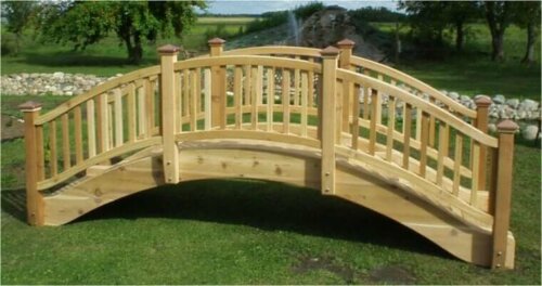 A wooden garden bridge before installation.