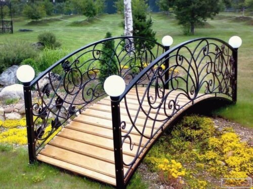 An iron and wood garden bridge.