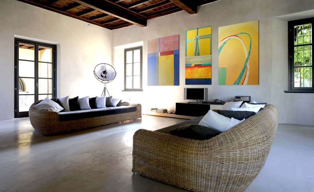 A spacious living room with contemporary art on the wall.
