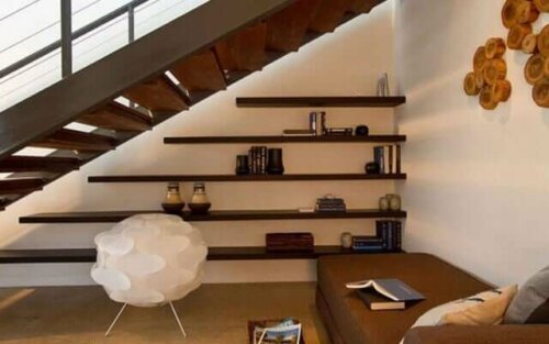 A shelving unit underneath a staircase.