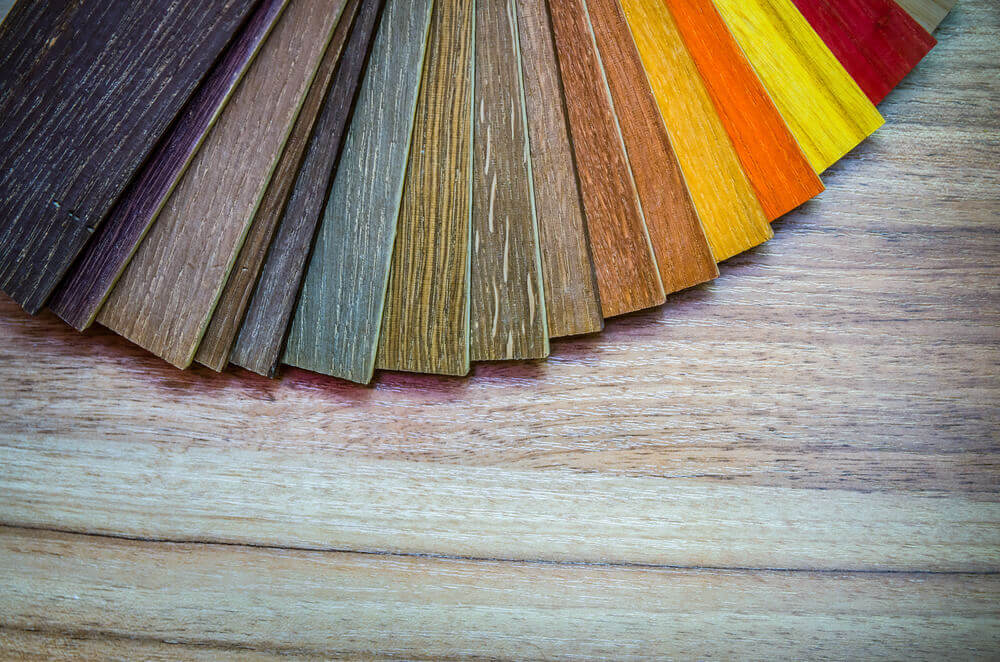 Dark flooring samples laid out.