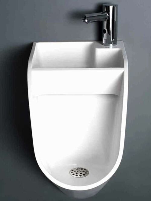 A urinal with a sink included.