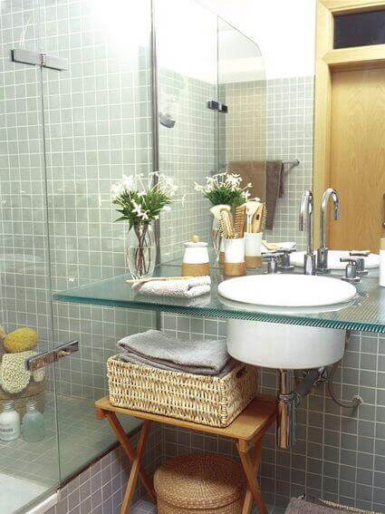A bathroom with a glass countertop.
