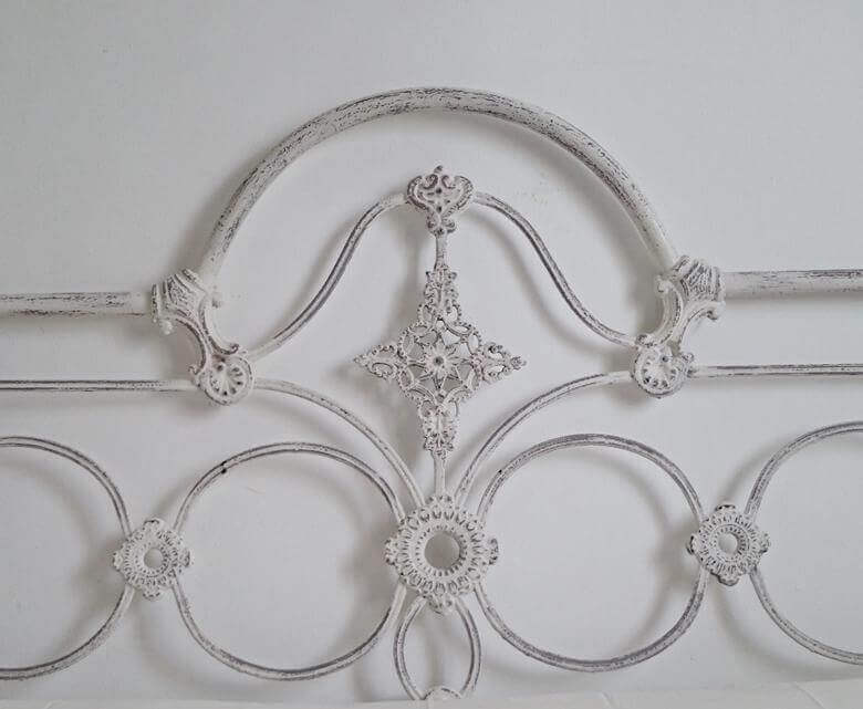 A headboard against a white wall.