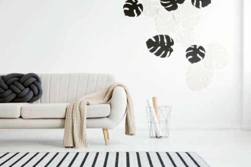 A beige sofa with a white wall behind it.