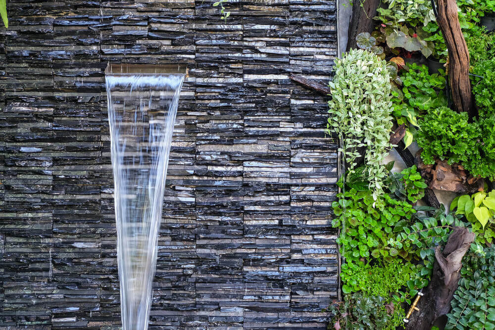 A spa fountain with water emerging from a wall.