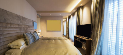 A bedroom with recessed light bulbs.