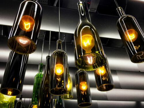 A lamp fixture made by reusing wine bottles.