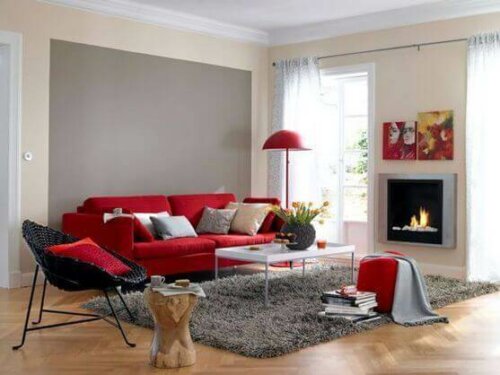 A room with a red color sofa.
