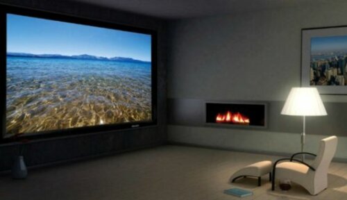 A room with a large screen and fireplace.