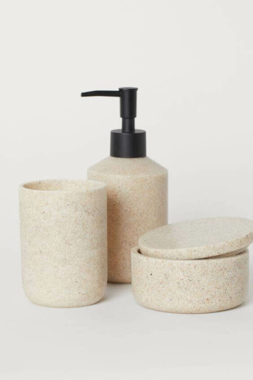 A beige mobile soap dispenser.