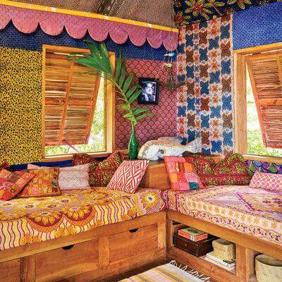A Jamaican style living room with intricate prints and colorful walls