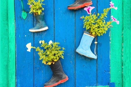 Recycled boots used as flower pots for outdoor decoration