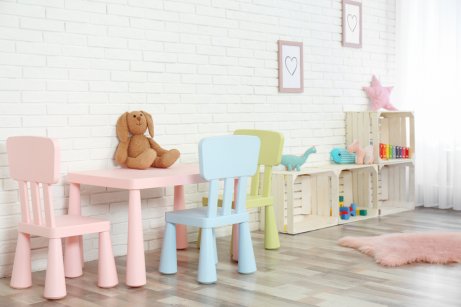 Using wooden fruit crates as short shelves for a pastel themed childrens library