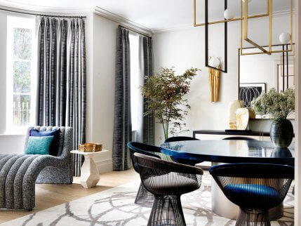 A blue and gray dining room designed by Natalia Miyar