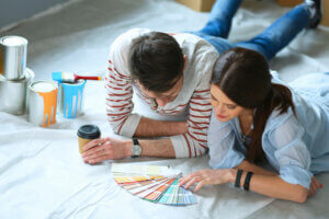 A couple deciding what paints to use.