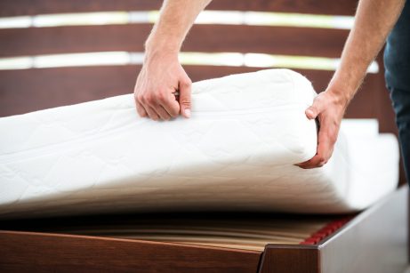 A man installing a foam mattress