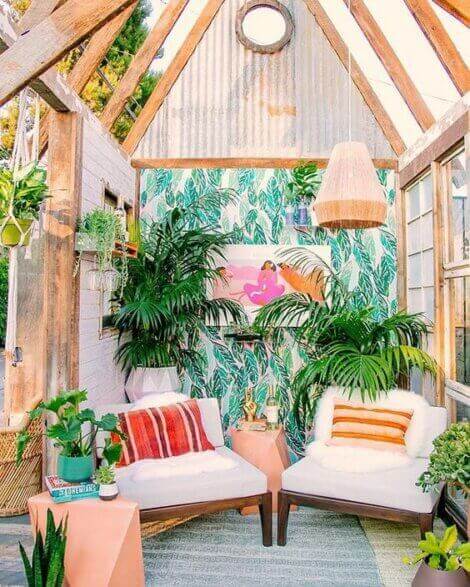 A Jamaican style living room with lots of tropical plants and a warm color palette