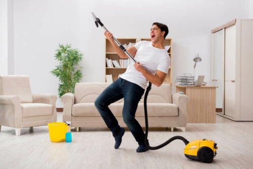A man vacuuming his living room.