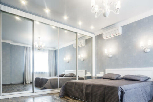 Mirrored sliding closet doors that add light to a bedroom.