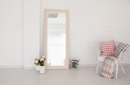 A room with a mirror up against the wall.