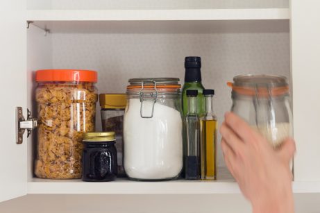 An organized pantry using reusable glass jars instead of plastic containers
