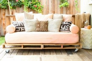 An outdoor pallet sofa with decorative cushions