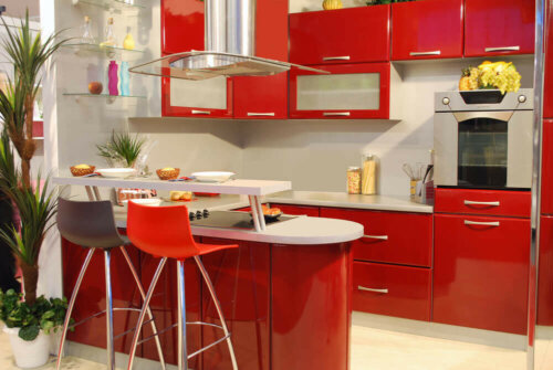 A red kitchen with white floors.