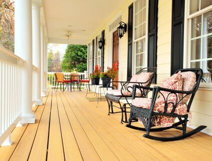 Rustic wooden porch with two rocking armchairs