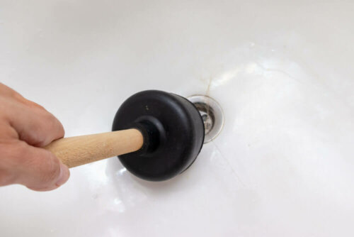 Someone cleaning a shower drain.