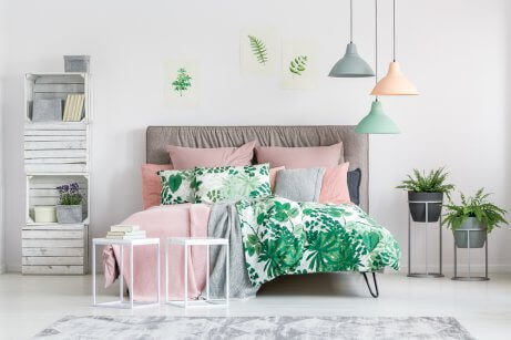 A cozy bedroom using a white, gray and pastel color pallete