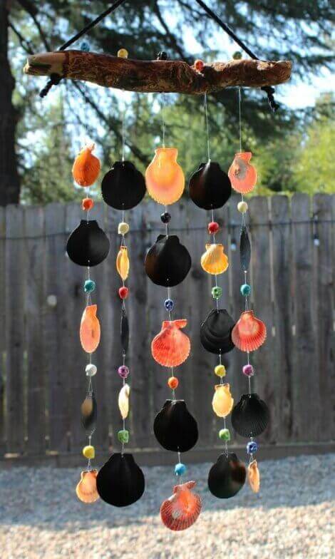 A wind chime made by hand with sea shells and other decorative elements