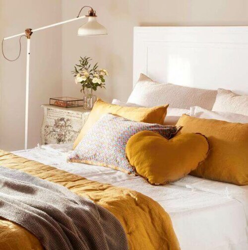 A bed decorated with throw pillows.