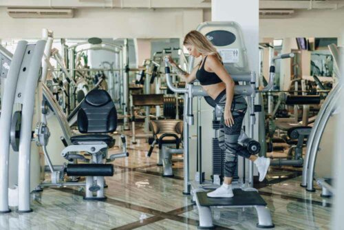 A woman using an exercise machine.