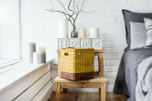 A bedroom with a wicker container on the nightstand beside it.
