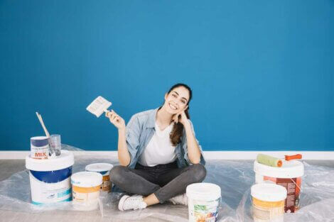 Woman with cans of paint ready to decorate