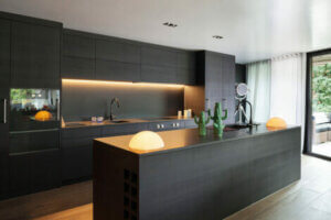 Black kitchen counters and cabinets.
