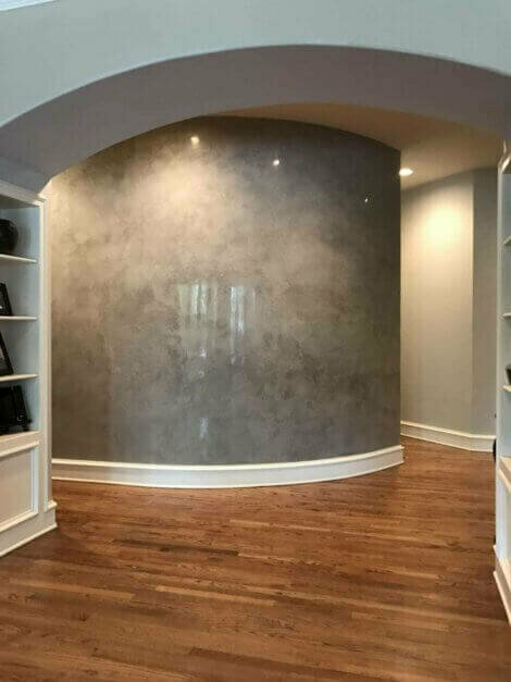 Gray curved wall in a hallway.