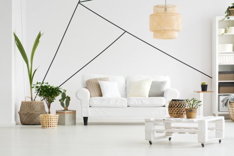 A living room with white walls and sofa