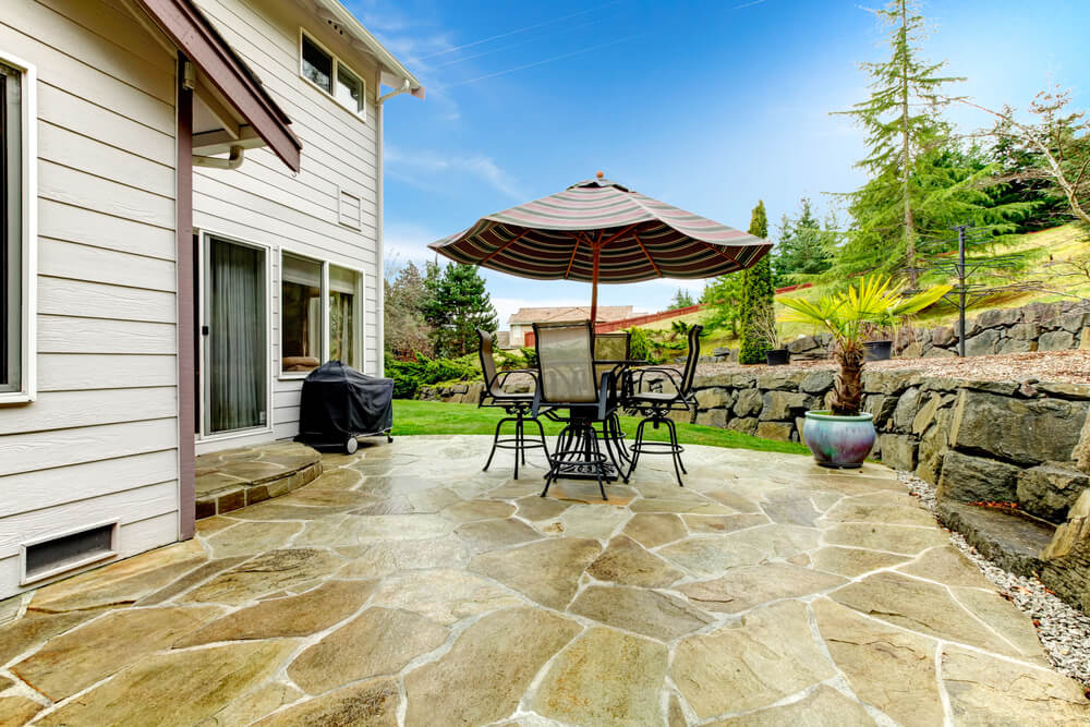 A backyard with a stone floor.