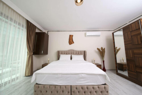 A bedroom with an air conditioner.