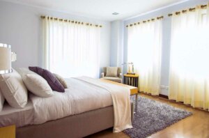A bedroom with curtains for better sleep.