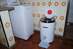 A mini washing machine in a kitchen.