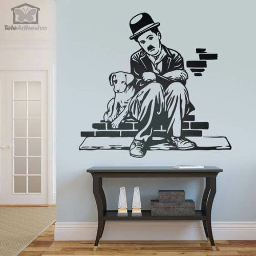 A print of Charlie Chaplin and his dog on a wall.