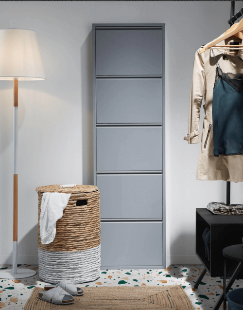 A tall shoe rack in a bedroom.