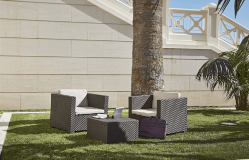 Some furniture on a lawn.