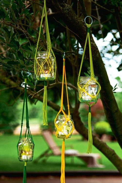 Some handmade lanterns hanging on a tree.
