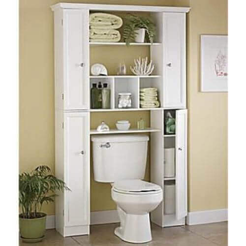 A cabinet over a toilet.