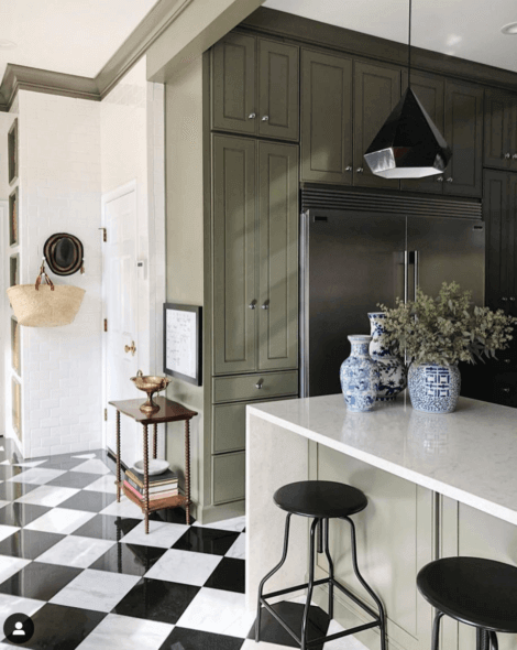 a kitchen with green cabinets